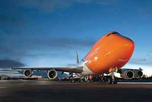 TNT branded aeroplanes being loaded on runway