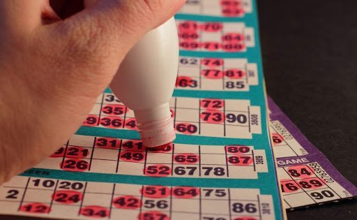 A hand daubing bingo card