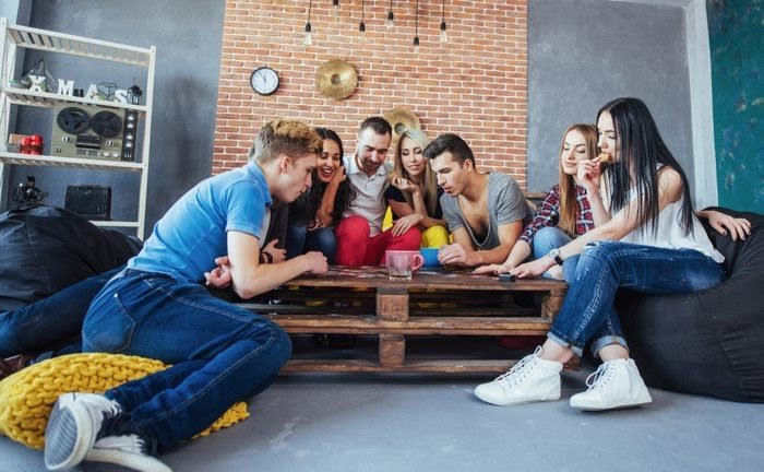 Young people playing a card game together